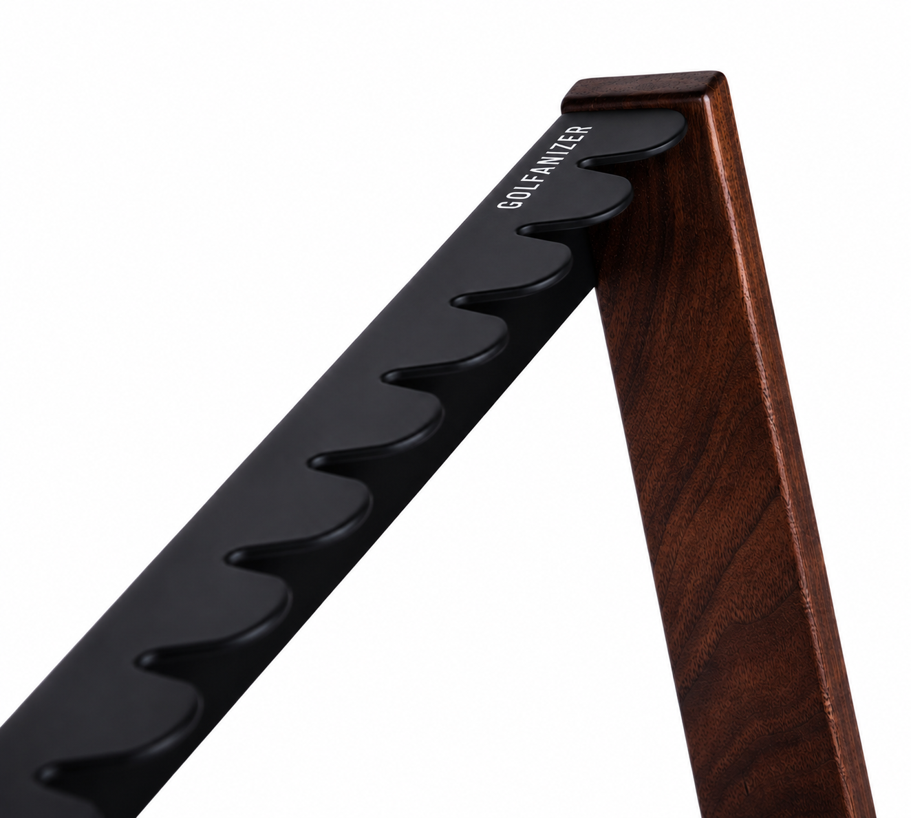 Macro of the soft-touch black club plate meeting solid walnut